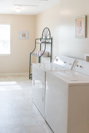 Spacious laundry room with full-size washer and dryer